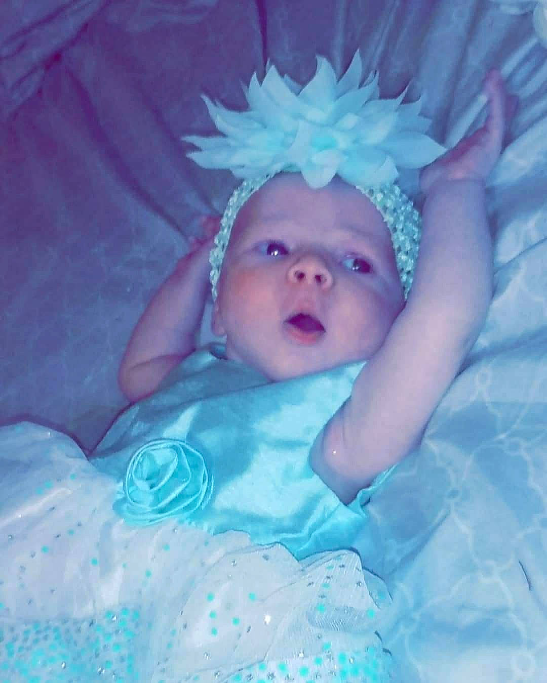 Kennedi is registered to the contest to win money with this photo: aqua, blue, child, eye, face, fun, girl, hair_accessory, head, infant, iris, mouth, person, product, purple, smile, toddler, turquoise