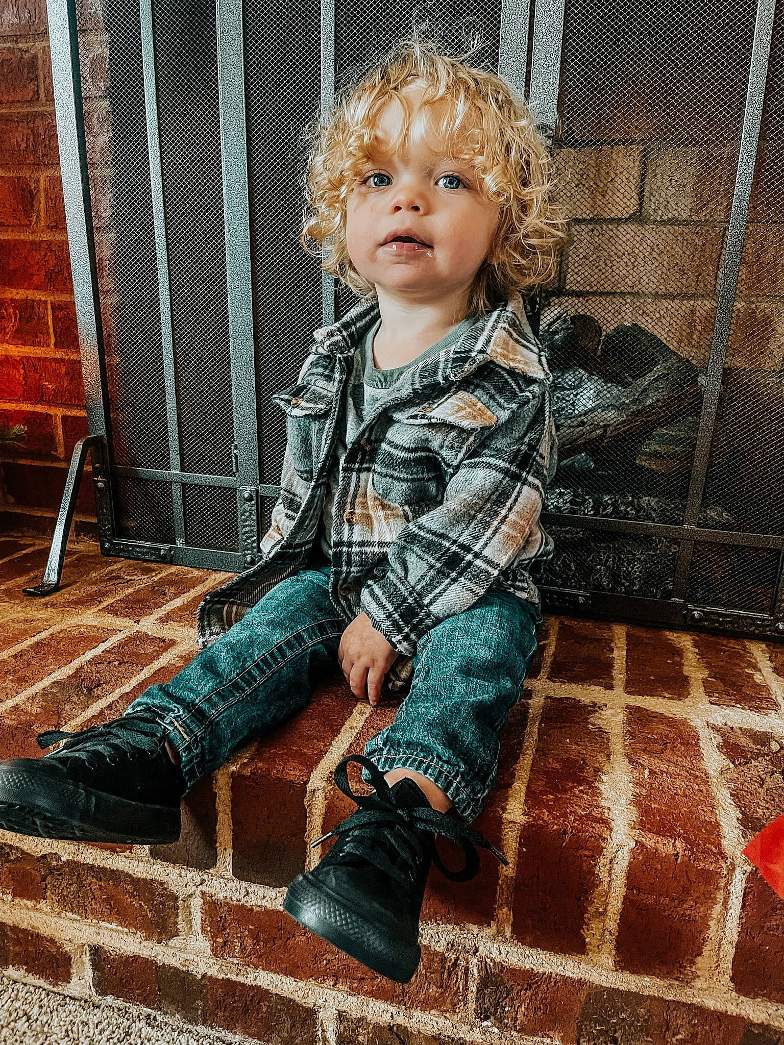 Lander is registered to the contest to win money with this photo: baby, brick, brickwork, brown_hair, chair, child, denim, flooring, fun, fur, human_leg, pattern, person, plaid, sitting, standing, tartan, textile, toddler, tree