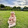 baby, child, grass, outdoor, park, trees, cloudy_sky, headband, pink_clothing, sitting, greenery, nature, infant, cute, happy, exploring, daylight, young_child, field, scenic