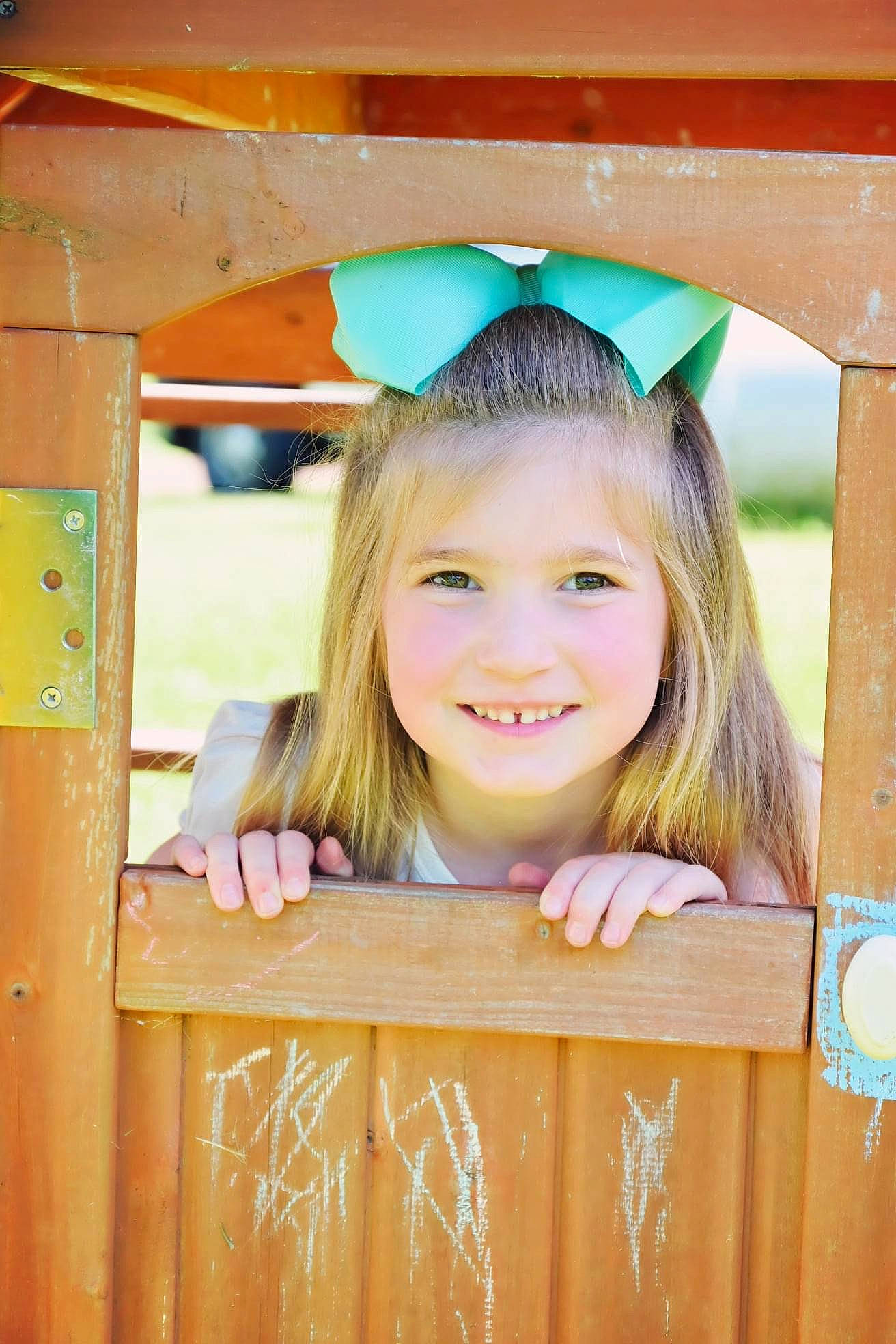 Berkley is registered to the contest to win money with this photo: beauty, blond, brown_hair, child, fence, fun, grass, happy, hardwood, joy, leisure, outdoor_play_equipment, person, play, playground, recreation, skin, smile, toddler, vacation