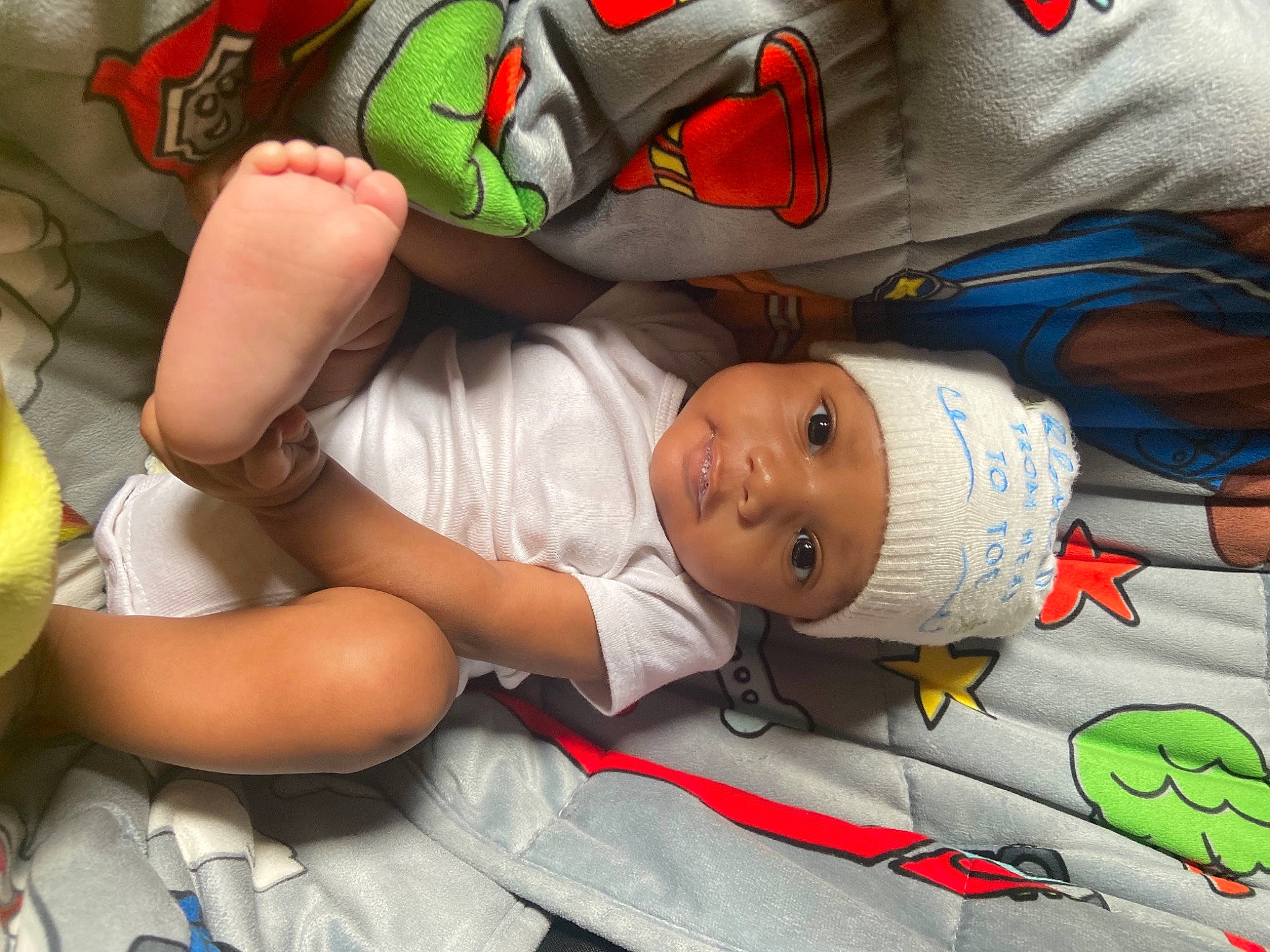 Major is registered to the contest to win money with this photo: arm, baby, baby_products, baby_sleeping, baby_toddler_clothing, carmine, child, comfort, elbow, hand, headwear, linens, mouth, nap, person, room, sleep, sleeve, t_shirt, toddler
