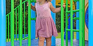 Isabella joined the competition — help win amazing prizes! child, toddler, playground, barefoot, curly_hair, pink_dress, green_bars, blue_platform, outdoor, trees, summer, play_equipment, adventure, young_child, grass, daytime, nature, fun, exploration, park