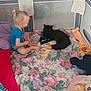 Ayden participe au concours pour gagner de l'argent avec cette photo : animal, black_cat, blanket, cat, child, child_playing, colorful, curious, cute, floor, floral_pattern, home, indoor, pet, pillow, playpen, relaxing, sitting, toddler, toy