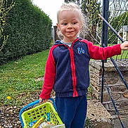 Ayden participe au concours pour gagner de l'argent avec cette photo : basket, candy, casual_clothing, child, daylight, grass, greenery, happy, holding, jacket, metal_railing, nature, outdoor, pants, person, playful, smile, stone_wall, toy, young_child