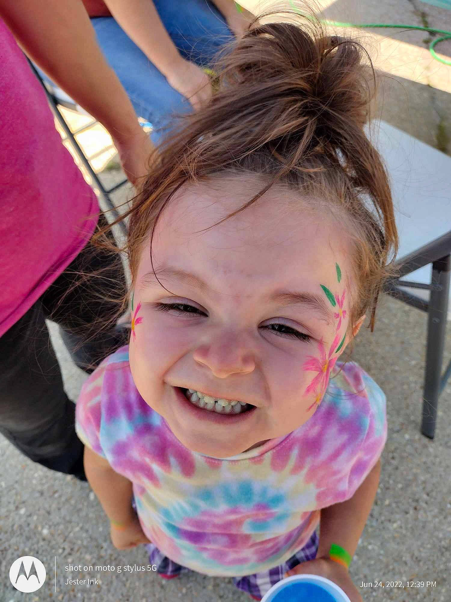 Deja is registered to the contest to win money with this photo: blue, child, eyewear, facial_expression, fashion_accessory, fun, grass, happy, leisure, mouth, outdoor_furniture, person, pink, play, recreation, sitting, skin, smile, summer, toddler