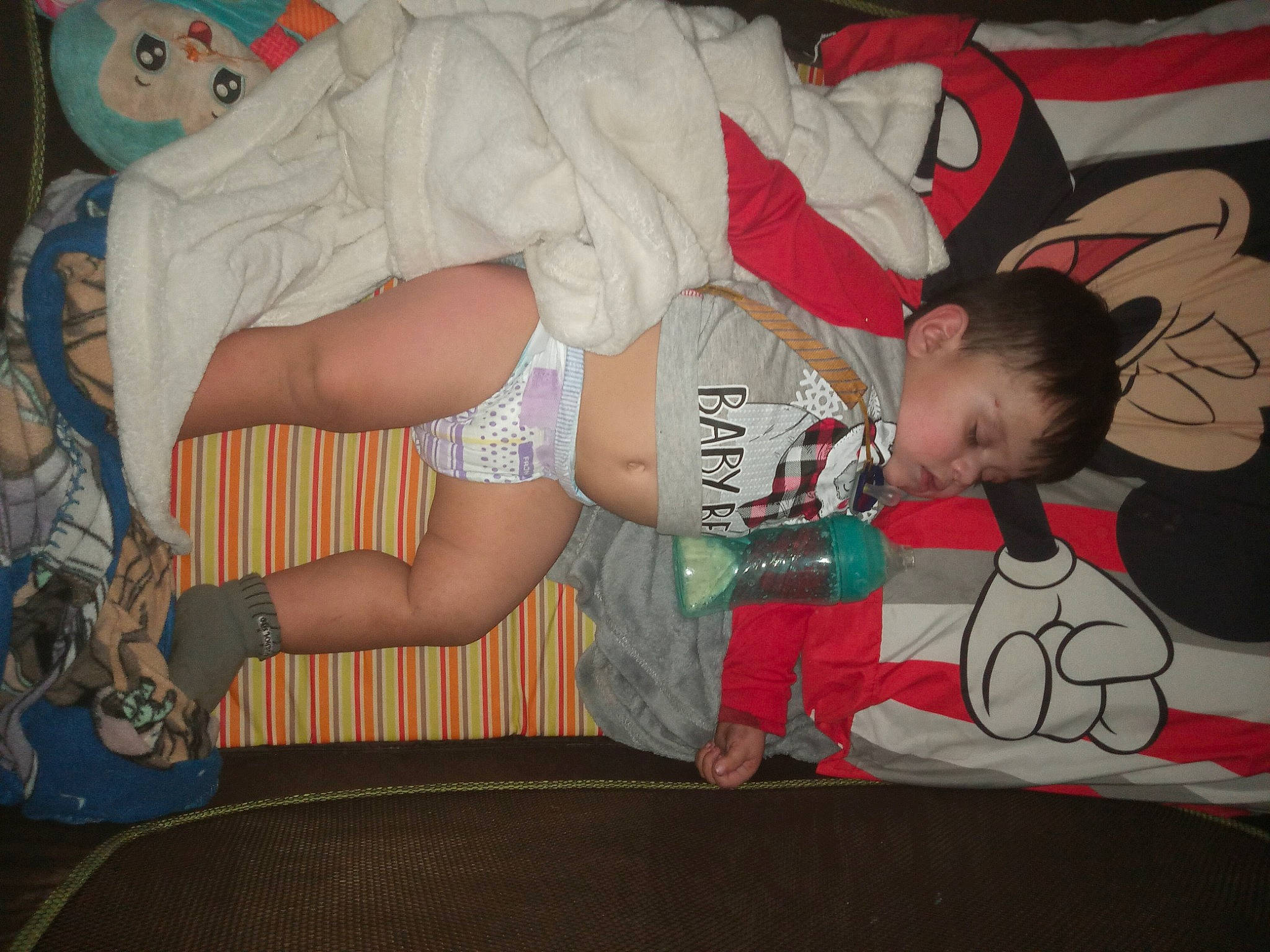 Luciano is registered to the contest to win money with this photo: baby, baby_toddler_clothing, carmine, child, comfort, elbow, fun, human_leg, knee, lap, leg, mouth, pattern, person, shorts, sitting, sock, t_shirt, thigh, toddler