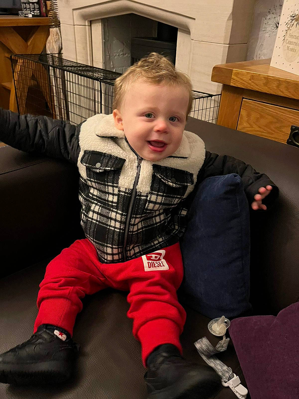 Jayden is registered to the contest to win money with this photo: baby, baby_toddler_clothing, cheek, comfort, cool, eye, fashion, floor, flooring, hairstyle, joint, knee, lap, outerwear, people, person, product, shoe, sleeve, sock