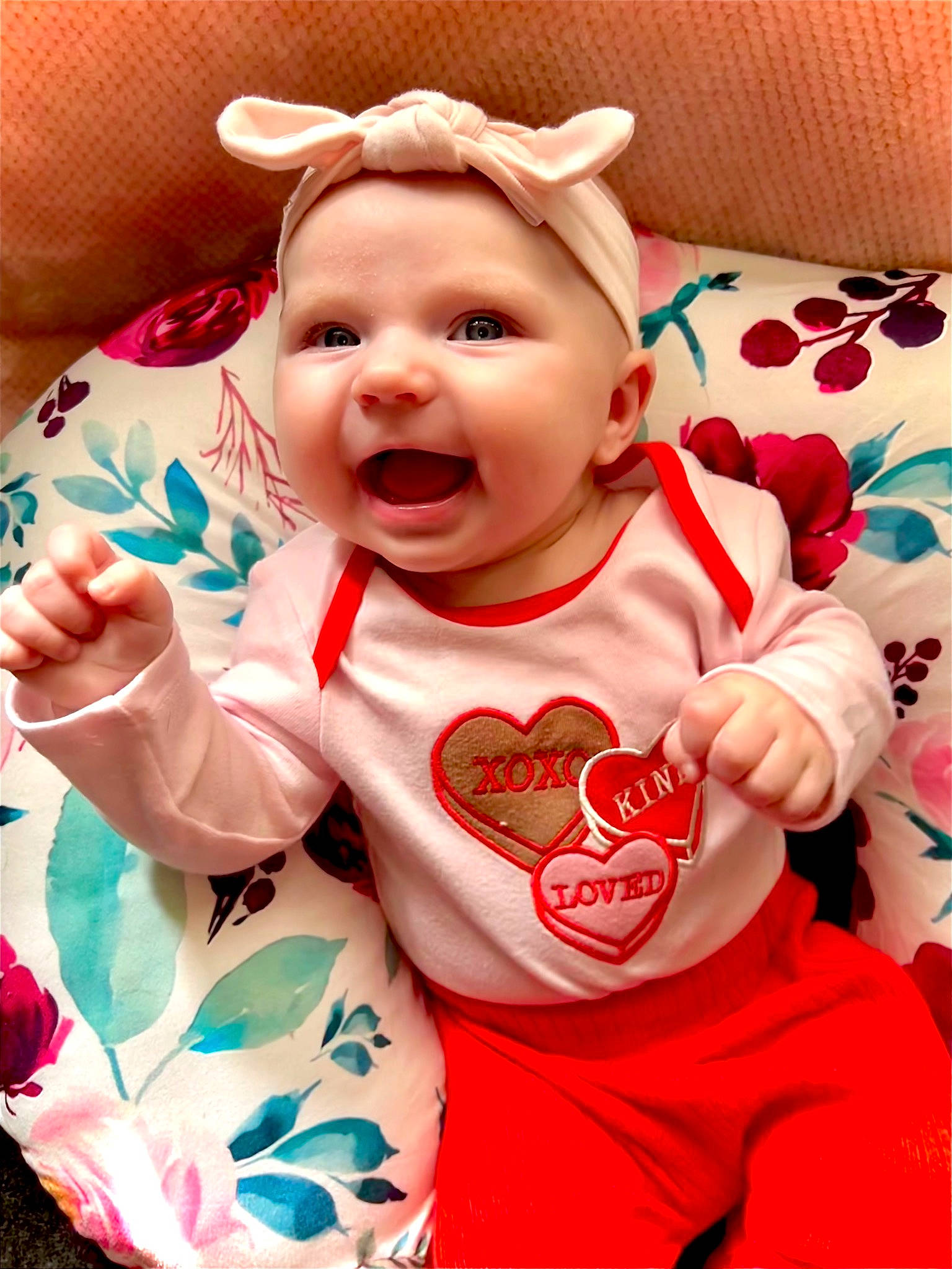 Hayden is registered to the contest to win money with this photo: baby, baby_laughing, baby_toddler_clothing, carmine, cheek, child, facial_expression, gesture, happy, head, headwear, human_body, mouth, pattern, person, pink, sleeve, smile, t_shirt, textile