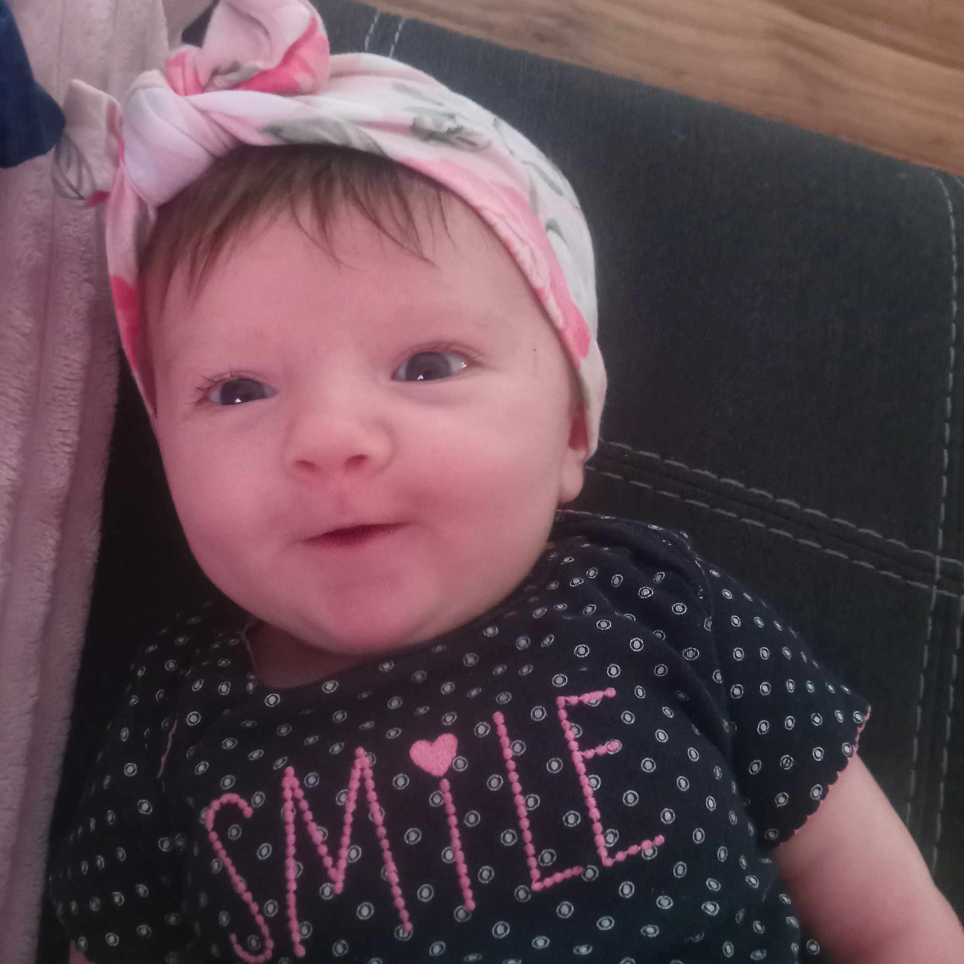 Georgia is registered to the contest to win money with this photo: accessories, baby, bonnet, cap, clothing, couch, cushion, face, furniture, hat, head, headband, homedecor, linen, newborn, pattern, person, photography, portrait, t_shirt