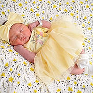 Carla joined the competition — help win amazing prizes! newborn, baby, sleeping, yellow, dress, headband, bow, blanket, floral, pattern, cute, infant, soft, cozy, peaceful, small, child, sock, lying, resting