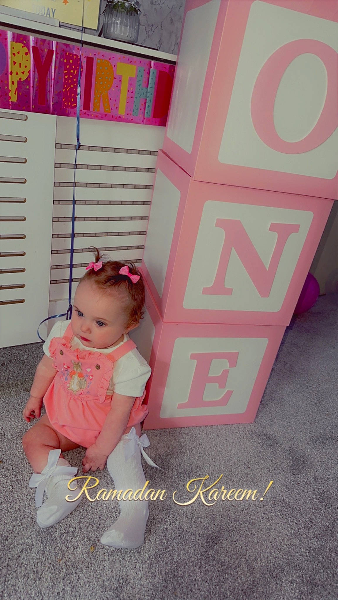 Esme is registered to the contest to win money with this photo: baby, baby_products, baby_toddler_clothing, child, flooring, font, happy, magenta, pattern, peach, person, pink, play, product, room, shelf, shelving, t_shirt, toddler, wheel