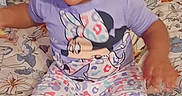 Wynter is registered to the contest to win money with this photo: baby, barefoot, bed, blanket, child, clothing, curious, cute, expression, face, floral_pattern, hand, head, indoor, minnie_mouse, pajamas, person, sitting, toddler, young_child
