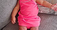 Wynter joined the competition — help win amazing prizes! baby, child, girl, pink_dress, headband, bow, couch, cushion, footwear, shoes, transparent_shoes, indoors, portrait, sitting, cute, adorable, infant, person, smile, fashion