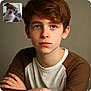 Joeby James joined the competition — help win amazing prizes! boy, child, portrait, face, blue_eyes, brown_hair, casual_clothing, raglan_shirt, puppy, dog, video_call, indoor, neutral_background, expressionless, arms_crossed, young, cute, pet, companion, technology