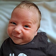Darii joined the competition — help win amazing prizes! baby, infant, face, smile, black_shirt, dinosaur_graphic, person, cute, child, portrait, closeup, indoor, skin, head, expression, clothing, newborn, young, happy, lying_down