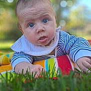 Darii joined the competition — help win amazing prizes! baby, infant, drool, blue_eyes, blanket, striped_clothing, outdoor, grass, bokeh, portrait, curious, child, young, face, skin, head, hand, nature, daylight, toddler