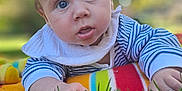 Darii joined the competition — help win amazing prizes! baby, infant, drool, blue_eyes, blanket, striped_clothing, outdoor, grass, bokeh, portrait, curious, child, young, face, skin, head, hand, nature, daylight, toddler