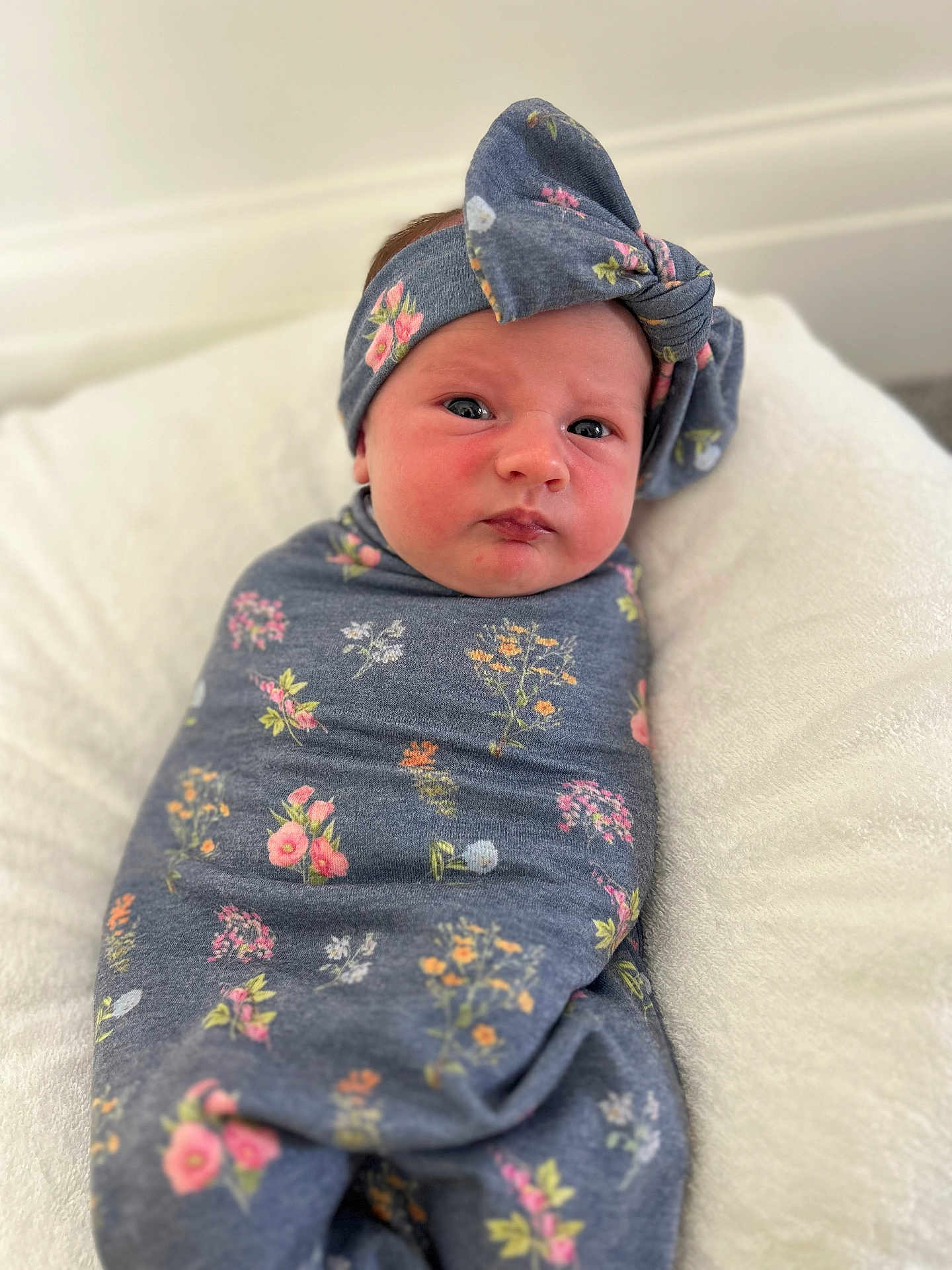 Eden-Rose joined the competition — help win amazing prizes! baby, newborn, swaddle, headband, floral_pattern, infant, cute, soft, blanket, lying_down, face, portrait, child, indoors, comfort, pink, blue, fabric, cushion, resting