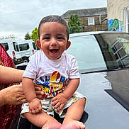 Vivian joined the competition — help win amazing prizes! baby, building, car, child, clothing, face, foot, graffiti, hand, happy, outdoor, person, shorts, sitting, sky, smiling, support, tshirt, urban, vehicle