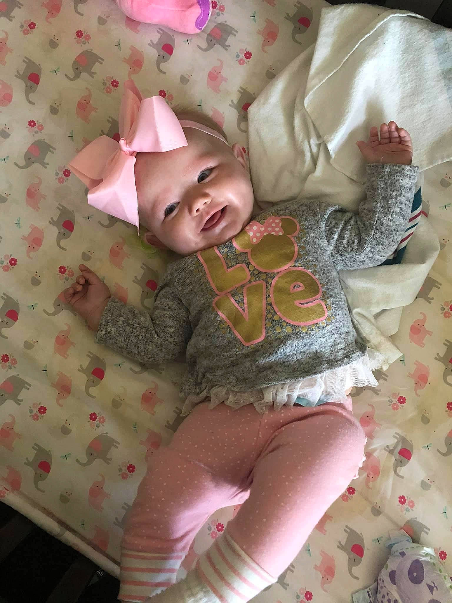 Macy joined the competition — help win amazing prizes! baby, baby_laughing, baby_products, baby_toddler_clothing, child, costume_accessory, headwear, linens, mouth, nightwear, pattern, person, pink, sleeve, sock, toddler