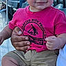 Nazarai is registered to the contest to win money with this photo: toddler, child, smiling, pink_shirt, shorts, outdoor, stadium, seating, person, hand, casual_clothing, daylight, happy, cute, baby, portrait, people, sitting, footwear, young_child