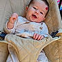 baby, infant, smile, onesie, animal_print, baby_seat, beige, padded, red_mark, happy, child, indoor, face, hand, clothing, seatbelt, comfort, portrait, young_child, cute