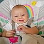 Lily is registered to the contest to win money with this photo: baby, smiling, infant, blanket, baby_chair, rainbow, sun, cute, happy, child, indoor, seat_belt, plush, clothing, comfort, portrait, face, hand, cozy, playful