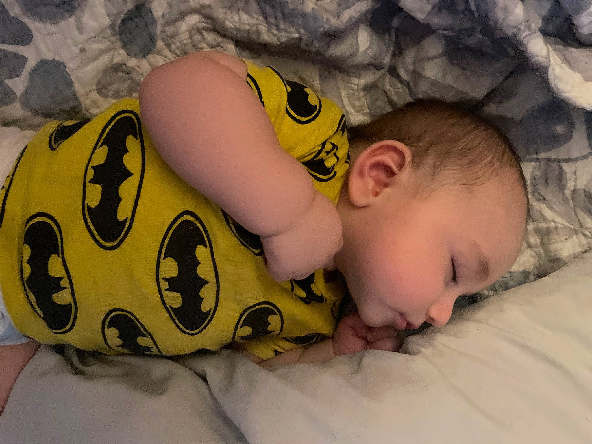 Jay is registered to the contest to win money with this photo: baby, baby_toddler_clothing, cheek, child, comfort, facial_expression, finger, happy, head, linens, mammal, mouth, nose, pattern, person, product, skin, textile, toddler, toy