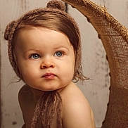 Jayden participe au concours pour gagner de l'argent avec cette photo : toddler, child, baby, portrait, face, blue_eyes, brown_hair, bear_ears, bonnet, soft_fabric, closeup, cute, expression, indoors, rustic_background, skin, headwear, young_child, cozy, neutral_expression