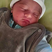 Maël participe au concours pour gagner de l'argent avec cette photo : baby, sleeping, hat, clothing, infant, face, peaceful, cozy, blanket, newborn, soft, resting, cute, child, portrait, closeup, indoors, warm, babywear, nap