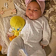 Leilani is registered to the contest to win money with this photo: baby, infant, child, portrait, lying_down, pink_bow, headband, onesie, polka_dots, plush_toy, yellow_toy, stuffed_animal, milestone_sign, four_months, lace, blanket, bedding, indoor, cute, cozy