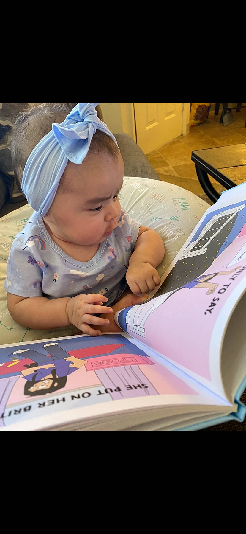 Aaylah is registered to the contest to win money with this photo: baby, baby_products, baby_toddler_clothing, carmine, child, flooring, fun, games, learning, leisure, person, play, product, reading, recreation, room, sitting, t_shirt, table, toddler