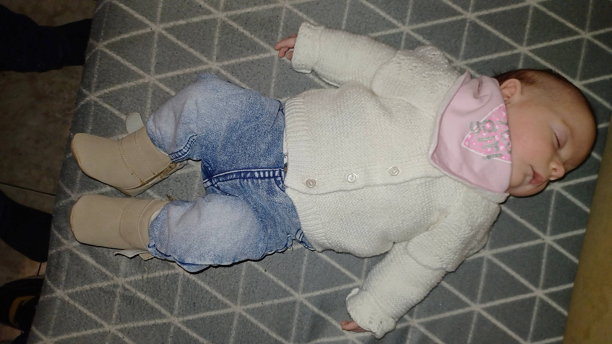 Aurore participe au concours pour gagner de l'argent avec cette photo : baby, baby_products, baby_toddler_clothing, comfort, concrete, denim, flooring, foot, fur, head, human_leg, knee, lap, leg, pattern, person, sitting, sock, thigh, toddler