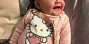 Yma Isabell is registered to the contest to win money with this photo: baby, smiling, pink_onesie, hello_kitty, pacifier_clip, chubby_cheeks, indoor, bed, pillow, blanket, cute, happy, child, infant, face, person, clothing, lying_down, soft_lighting, head