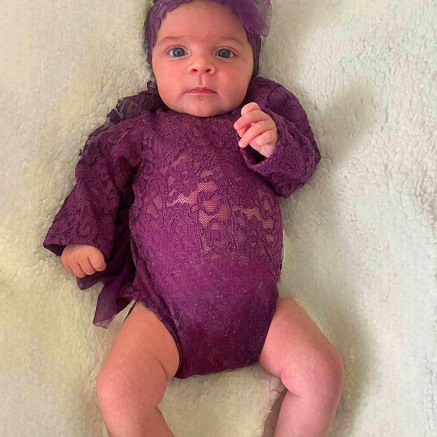 Emma participe au concours pour gagner de l'argent avec cette photo : baby, bodypart, clothing, crawling, dress, face, finger, hair, hand, happy, head, knitwear, longsleeve, person, photography, portrait, sitting, sleeve, sweater, toy