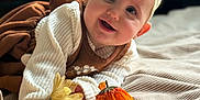 Riley is registered to the contest to win money with this photo: baby, baby_girl, blanket, bow, child, clothing, cozy, cute, decor, face, fireplace, flower, happy, headband, indoor, infant, portrait, smile, soft_texture, warm_light