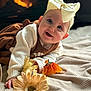 baby, baby_girl, blanket, bow, child, clothing, cozy, cute, decor, face, fireplace, flower, happy, headband, indoor, infant, portrait, smile, soft_texture, warm_light