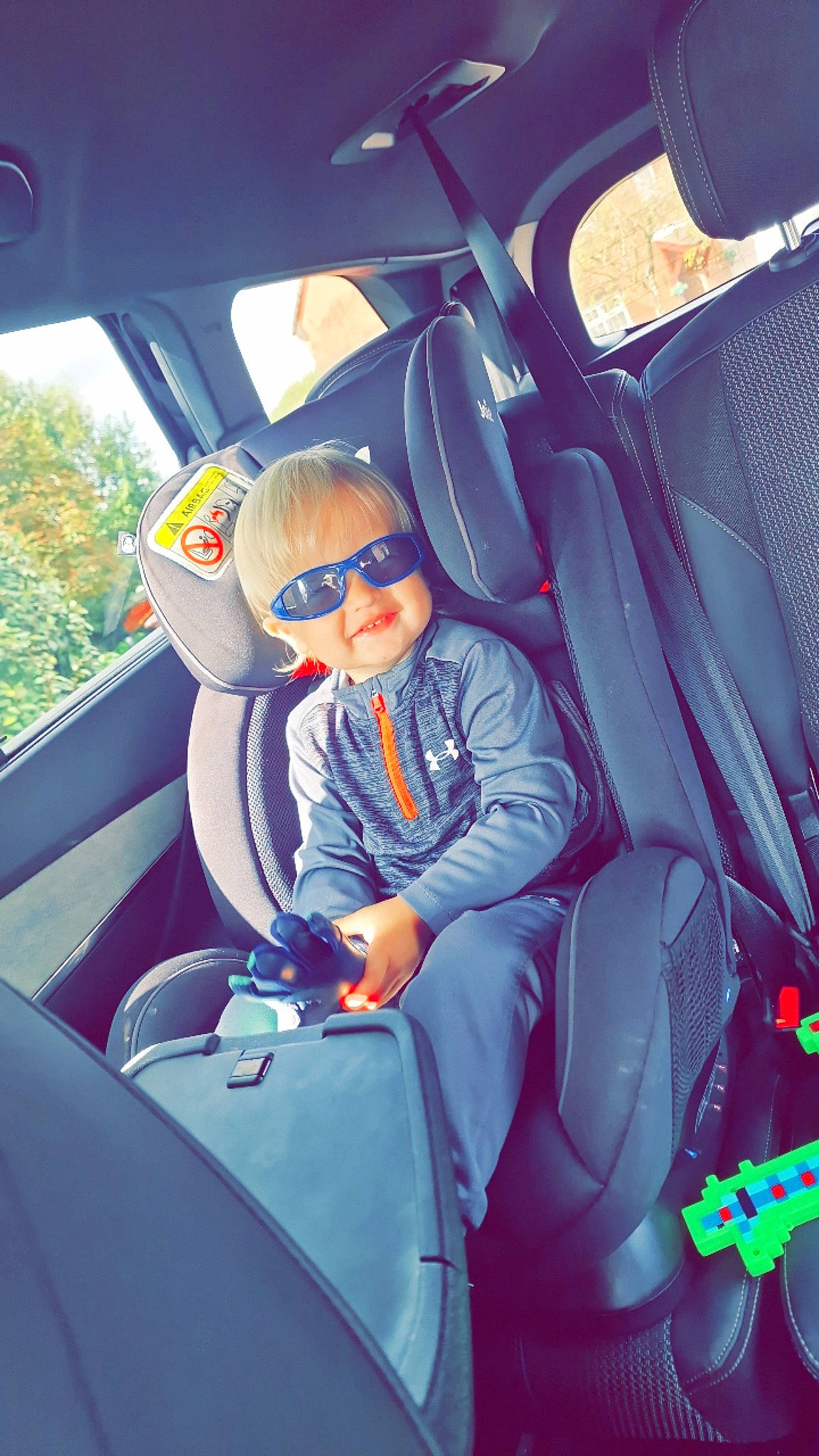 Jaxson is registered to the contest to win money with this photo: auto_part, automotive_design, automotive_exterior, car, car_seat, car_seat_cover, comfort, electric_blue, glasses, goggles, head_restraint, motor_vehicle, person, personal_luxury_car, seat_belt, steering_part, steering_wheel, sunglasses, toddler, vehicle
