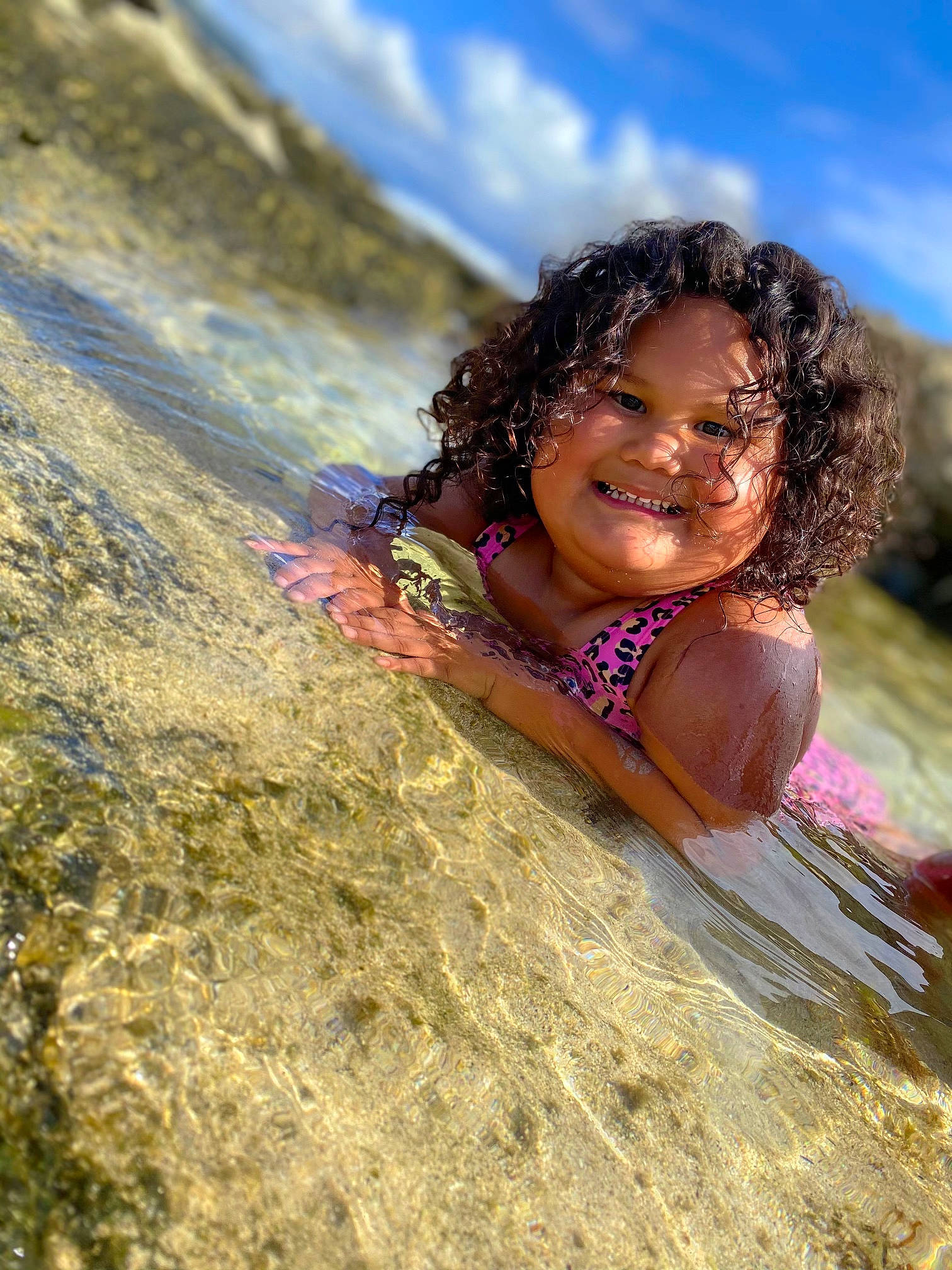 Jeihzlee is registered to the contest to win money with this photo: cloud, face, flash_photography, fun, grass, happy, head, joy, landscape, leisure, long_hair, people_in_nature, person, recreation, sand, sky, smile, sunlight, swimwear, toddler