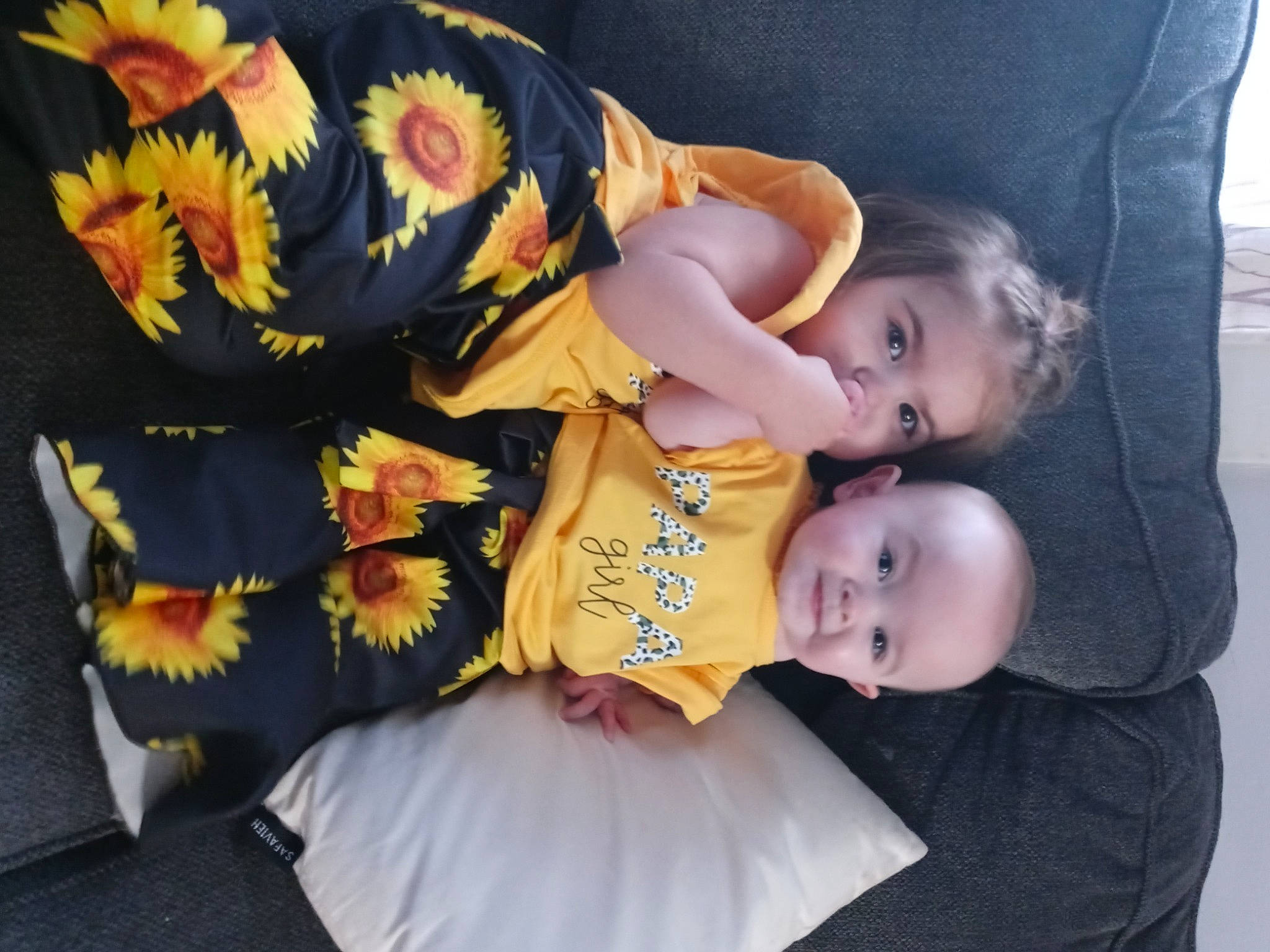 Brezlynn is registered to the contest to win money with this photo: baby, baby_products, baby_toddler_clothing, child, comfort, dress, event, flower, fun, hairstyle, happy, human_body, lap, people, person, photograph, plant, room, sitting, toddler