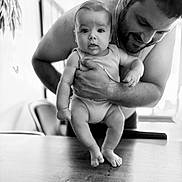 Rafaël a rejoint le concours — aidez-le/la à gagner de superbes lots ! arm, baby, black_and_white, child, closeup, curious, expression, face, furniture, hand, happy, holding, indoor, love, man, person, portrait, skin, smiling, table