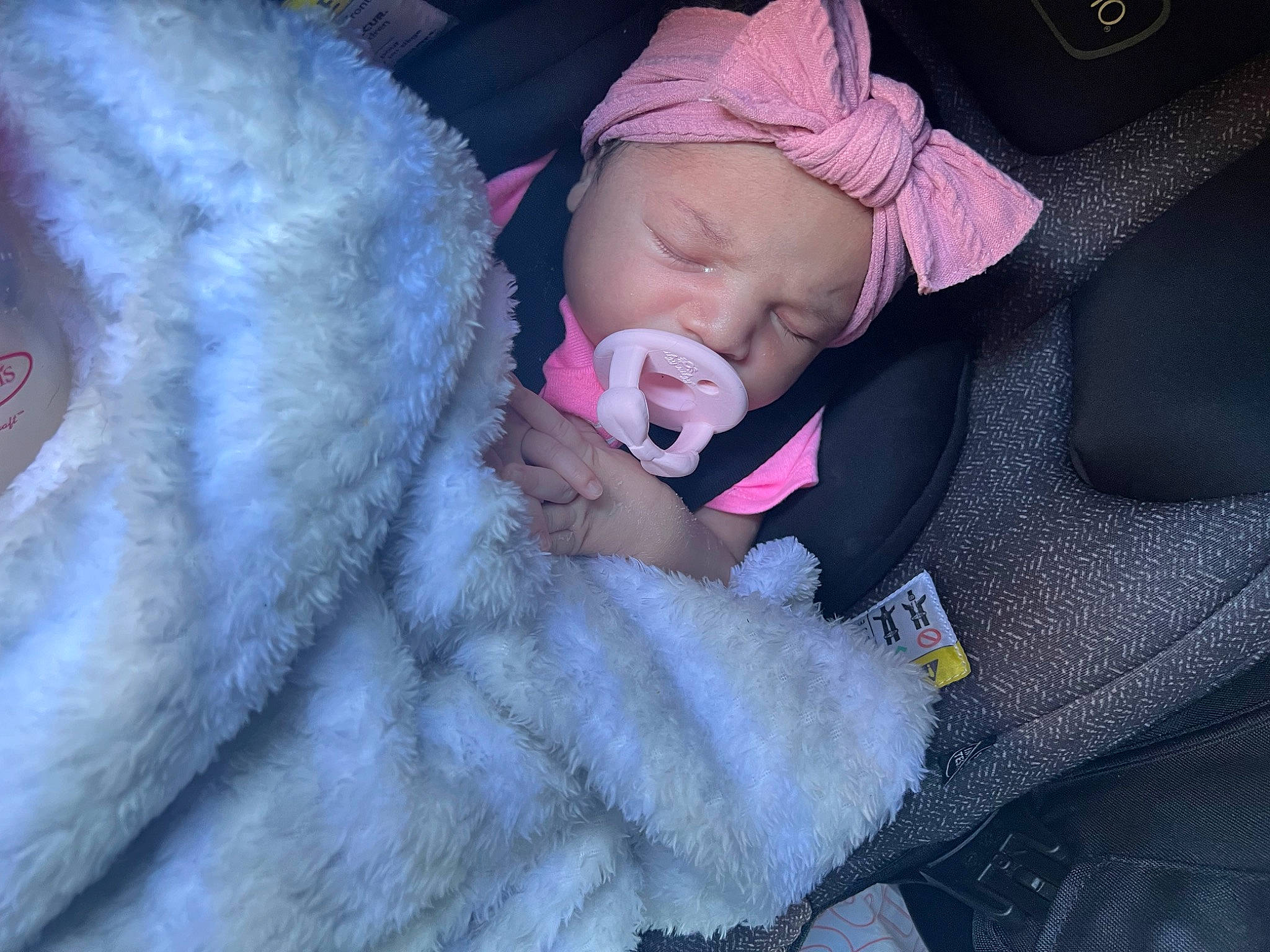 Amira is registered to the contest to win money with this photo: baby, baby_in_car_seat, baby_products, baby_sleeping, baby_toddler_clothing, car_seat, comfort, electric_blue, fur, gesture, grey, hat, headwear, linens, magenta, nail, person, purple, textile, toddler