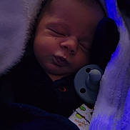 John joined the competition — help win amazing prizes! baby, sleeping, blanket, pacifier, infant, soft, cozy, dark, blue_light, face, newborn, child, wrapped, peaceful, cute, clothing, portrait, resting, indoors, warm