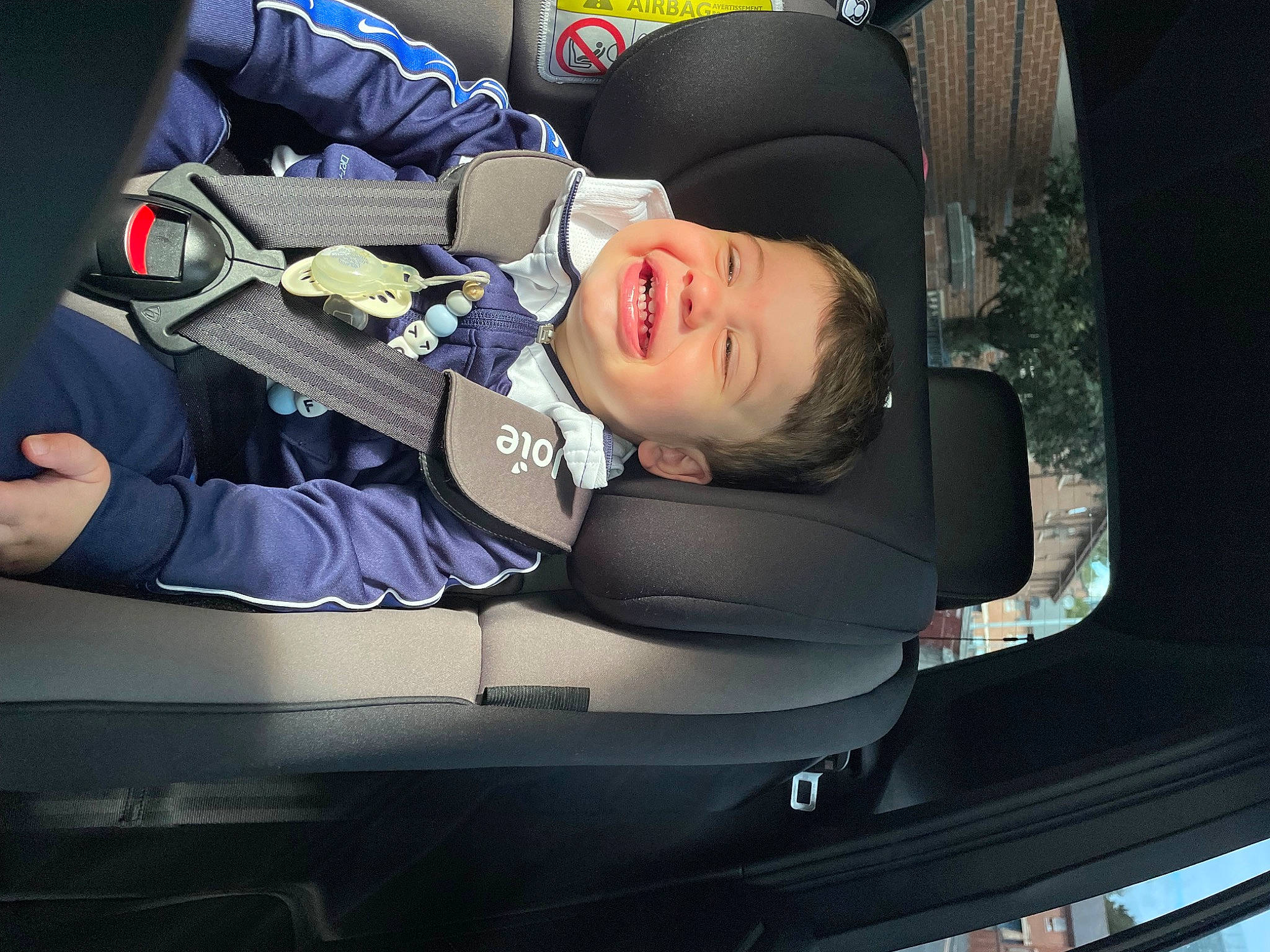 Freddy is registered to the contest to win money with this photo: auto_part, automotive_design, automotive_exterior, automotive_window_part, baby_in_car_seat, car_seat, car_seat_cover, comfort, family_car, head_restraint, joy, motor_vehicle, person, personal_luxury_car, seat_belt, smile, steering_part, steering_wheel, toddler, vehicle