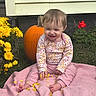 Lillith joined the competition — help win amazing prizes! baby, child, smiling, autumn, pumpkin, flowers, garden, outdoor, pink_blanket, floral_clothing, sitting, portrait, happy, infant, petals, yellow_flowers, red_flowers, grass, seasonal, family_photo