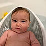 baby, bathtub, child, water, wet_hair, skin, face, blue_eyes, indoor, bath_time, cute, infant, relaxing, portrait, baby_bath, plush, soft_light, baby_skin, childhood, young