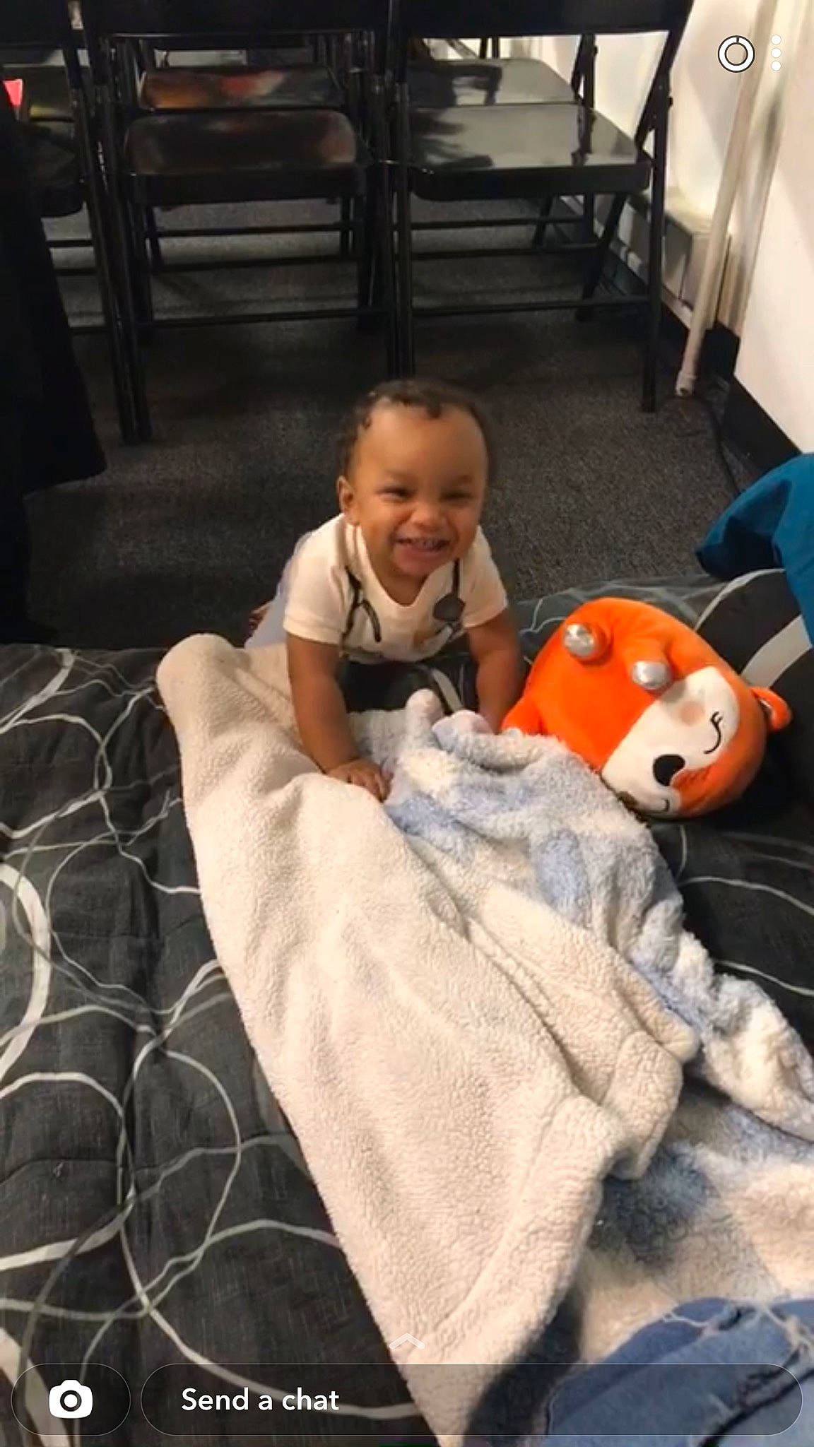 Josiah is registered to the contest to win money with this photo: baby, baby_toddler_clothing, chair, child, comfort, doll, facial_expression, floor, flooring, fun, joy, lap, linens, mouth, person, play, pumpkin, sitting, stuffed_toy, textile