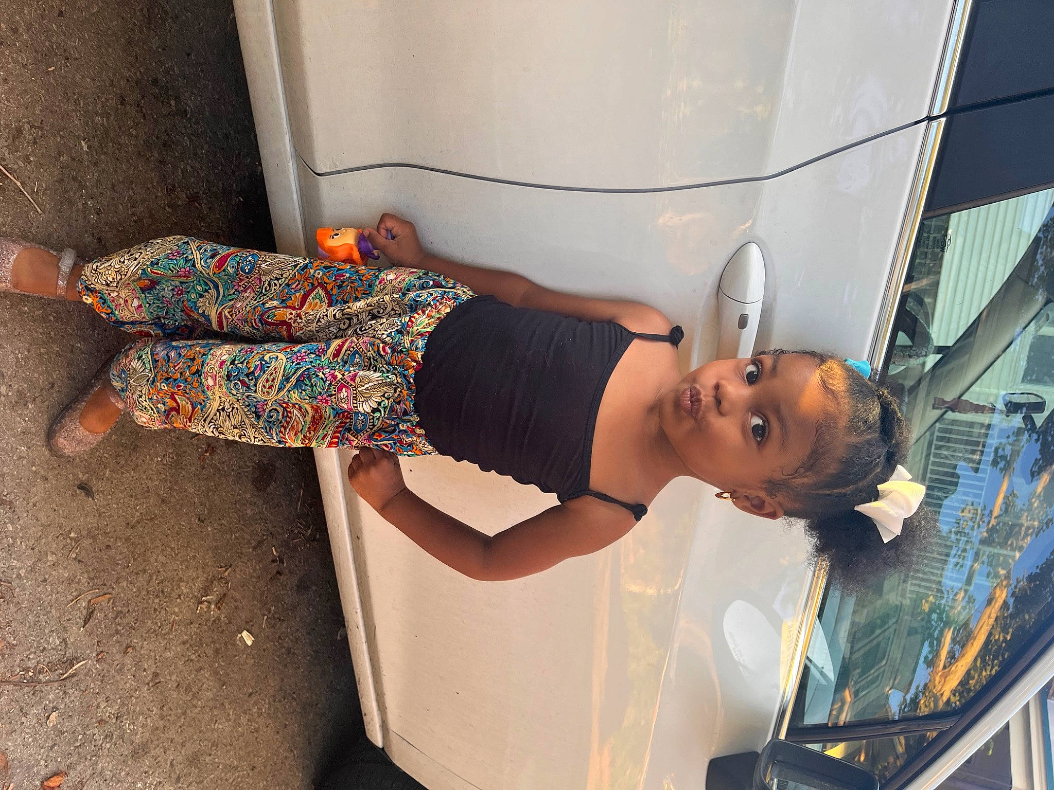 Azyah is registered to the contest to win money with this photo: automotive_design, child, dress, elbow, eyewear, fun, hat, human_body, human_leg, knee, leisure, major_appliance, person, room, sandal, smile, t_shirt, thigh, waist