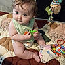 Natalie is registered to the contest to win money with this photo: baby, child, infant, play_mat, toy, plush_toy, colorful, curious, sitting, indoors, diaper, green_toy, orange_toy, cute, chubby_cheeks, tousled_hair, playtime, soft_toys, person, floor