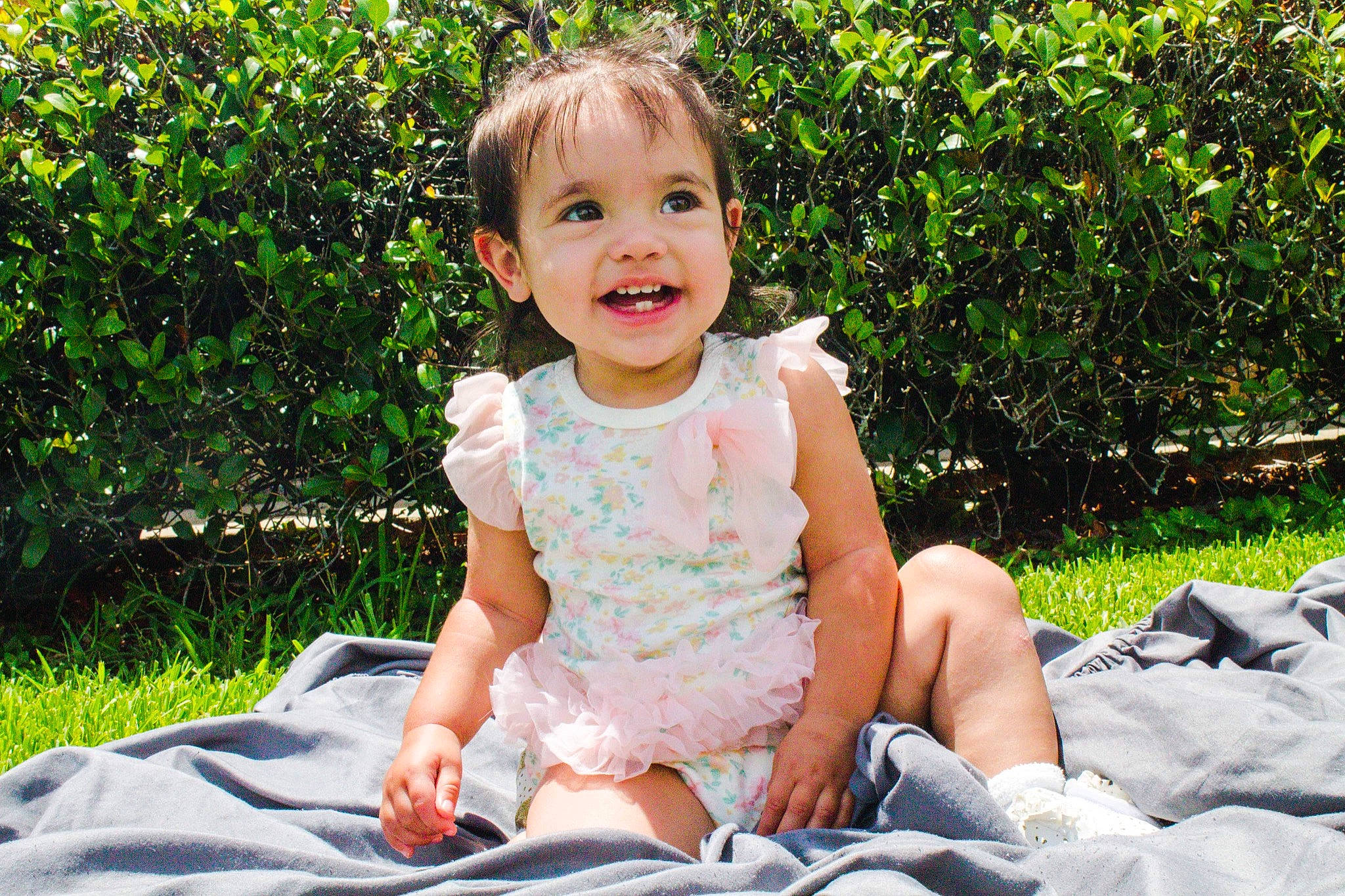 Haislee joined the competition — help win amazing prizes! baby, baby_laughing, baby_toddler_clothing, child, dress, fun, grass, happy, joy, leisure, pattern, people_in_nature, person, plant, shorts, sitting, sleeve, smile, summer, t_shirt